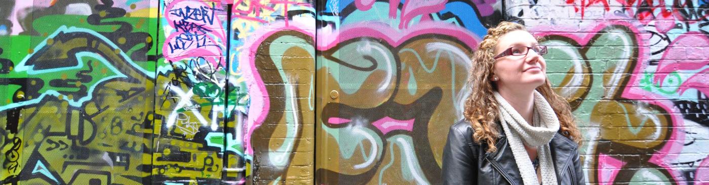 Woman in laneway with graffiti in Fitzroy, Melbourne